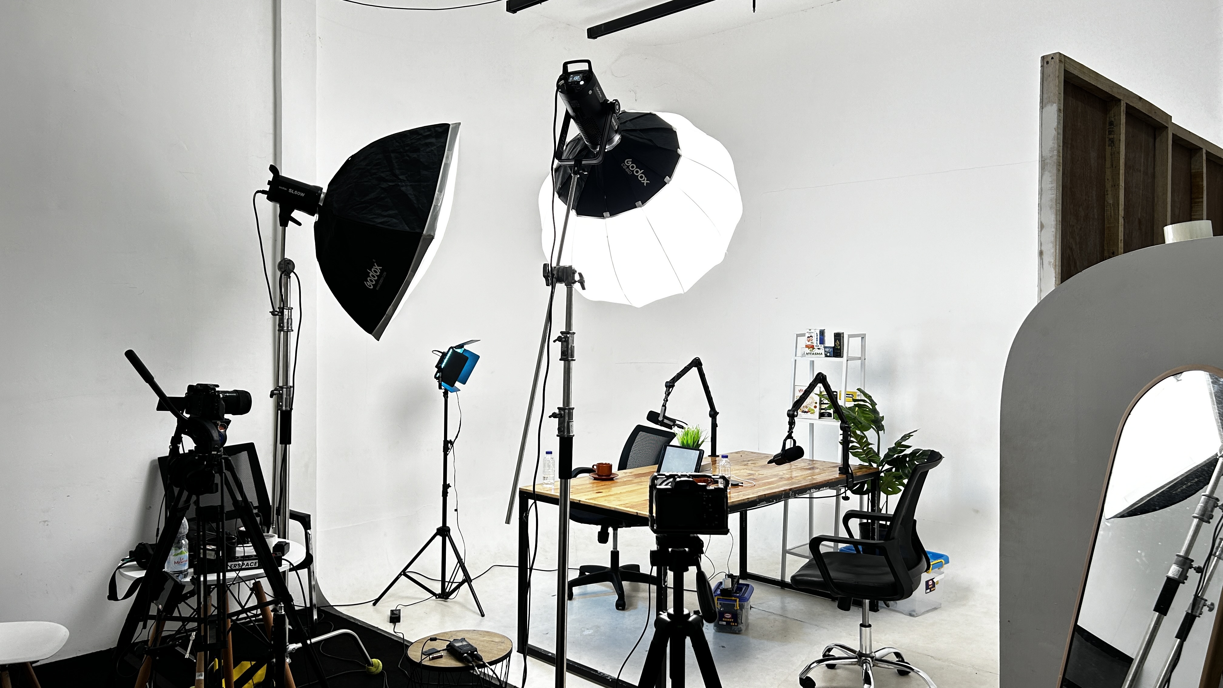 Podcast studio with cameras, lighting equipment and microphones