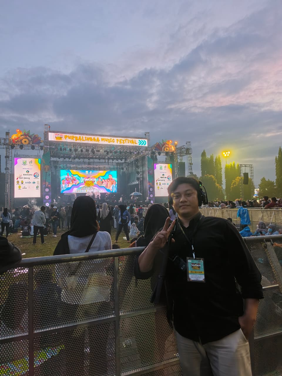 WahidPro wearing a headset beside the festival stage