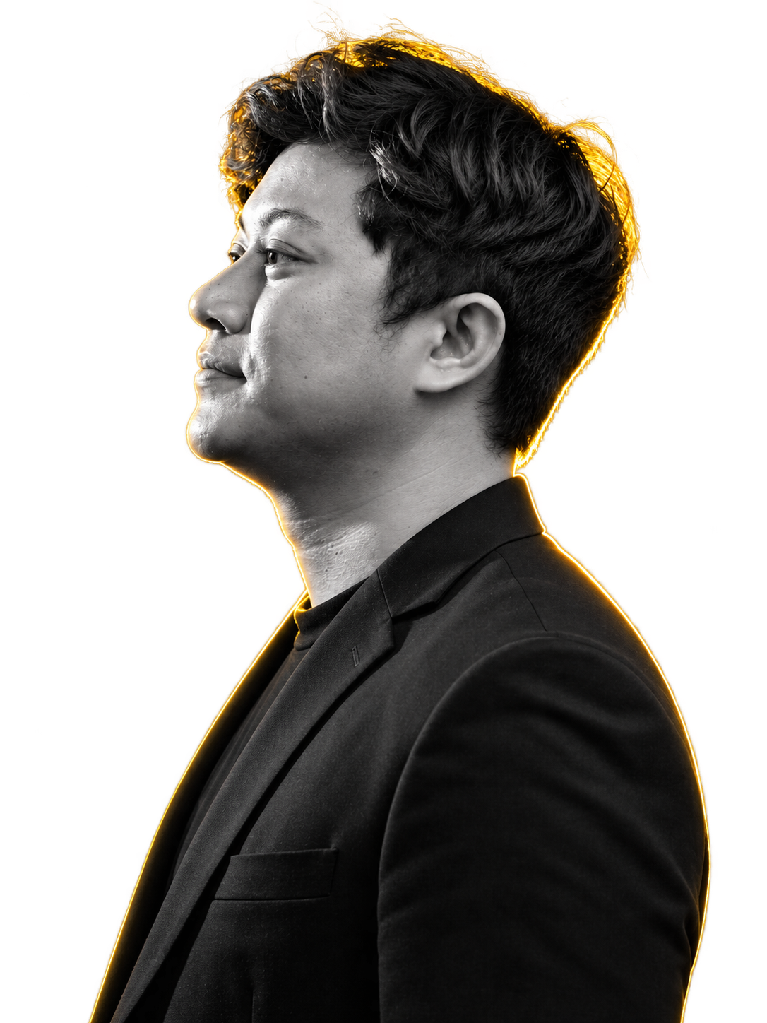 Side portrait of WahidPro in a black jacket with golden rim lighting